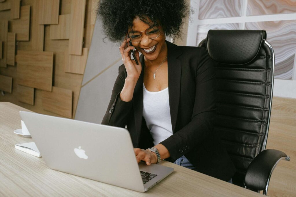 Mujer profesional trabajando en computadora en oficina moderna, representando la evolución del marketing digital con agentes de IA